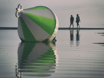Close-up of buoy on water at beach