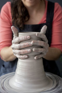 Close-up of woman holding hand in mud