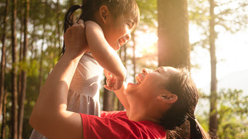 Side view of father and boy looking at camera
