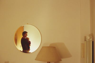 Father with baby reflecting on mirror