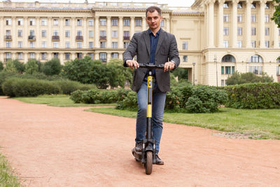 Rear view of man riding bicycle