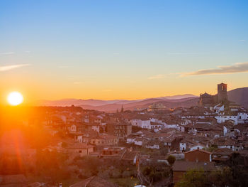 High angle shot of townscape against sky at sunset