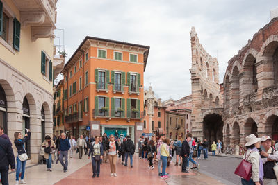 People in front of buildings against sky