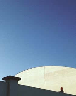 Low angle view of built structure against clear blue sky