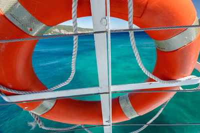 Close-up of boat moored in sea against sky