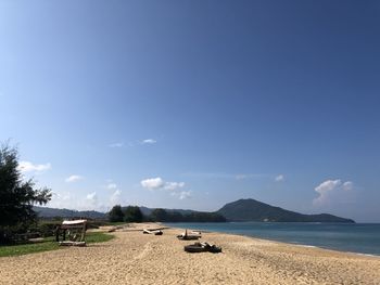 Scenic view of beach against blue sky