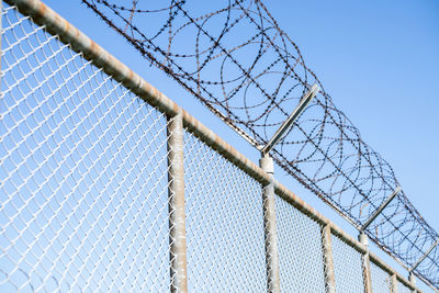 Prison security fence. barbed wire border security fence. razor wire jail fence. barrier border. 