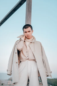 Full portrait of a young man standing in the field