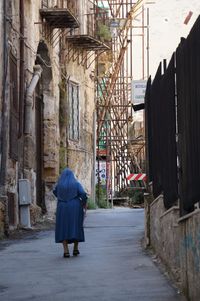 Rear view of a man walking on street