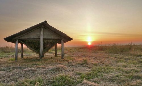 Scenic view of sunset over field