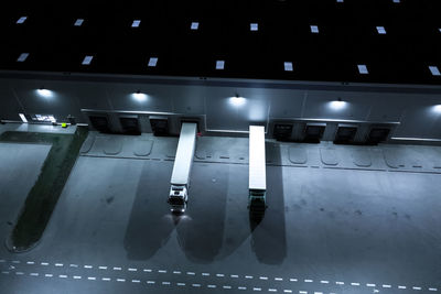 Aerial view of goods warehouse at night. logistics center in industrial city zone from above. 