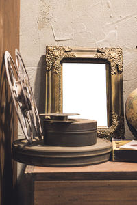 Close-up of window on table against wall