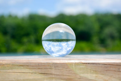 Close-up of crystal ball on wooden surface