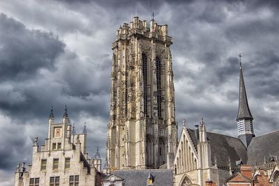 Panoramic view of buildings in city against cloudy sky