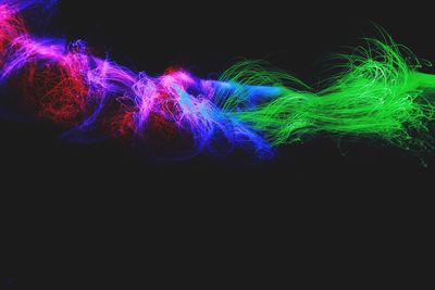 Close-up of illuminated light painting against black background