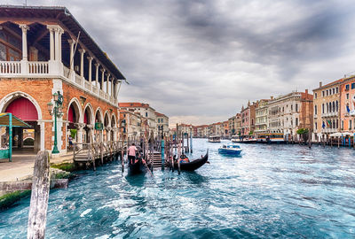 Boats in canal along buildings