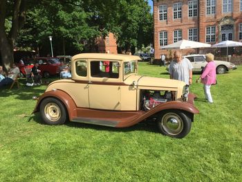 Vintage car parked on golf course