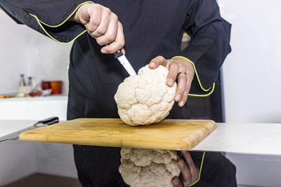 Midsection of man preparing food on table at home