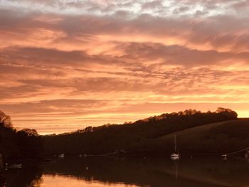 Scenic view of lake against orange sky