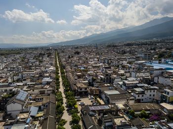 High angle view of houses in town against sky