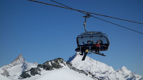 Low angle view of ski lift against clear sky