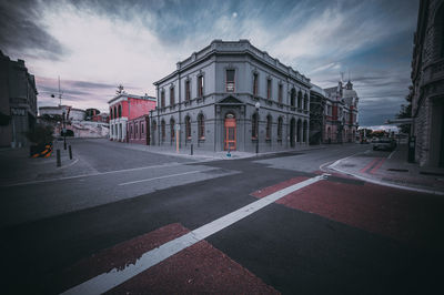 City street and buildings against sky