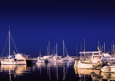 Sailboats moored in harbor