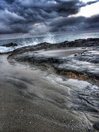 View of beach against cloudy sky