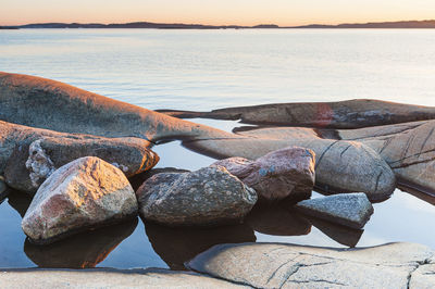 Stones lying in water in front of sea