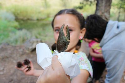 Close-up of girl holding crab claw