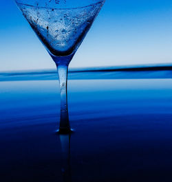 Close-up of water in sea against clear blue sky