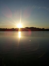 Scenic view of lake at sunset