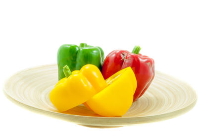 Close-up of yellow bell peppers against white background