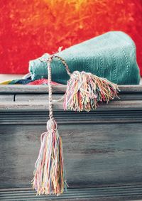 Close-up of tied hanging on rope against wall