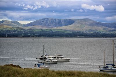 Scenic view of sea and mountains against sky