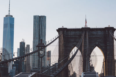 Low angle view of brooklyn bridge against sky in city