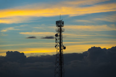 Low angle view of communications tower against sky during sunset