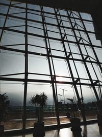 Low angle view of building seen through glass window