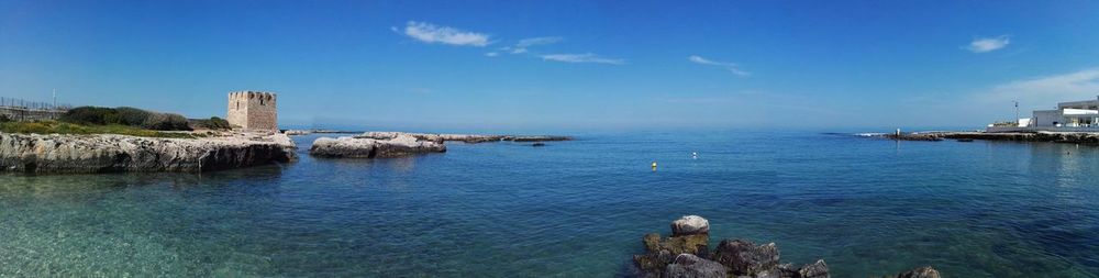 Panoramic view of sea against blue sky