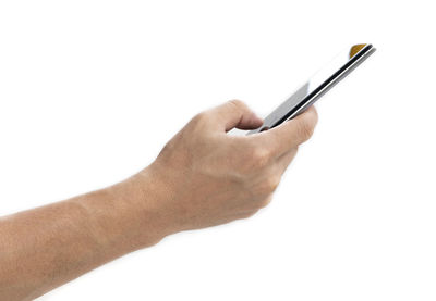 Close-up of hand holding smart phone against white background
