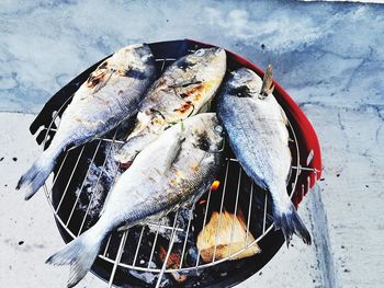 High angle view of fish on barbecue grill