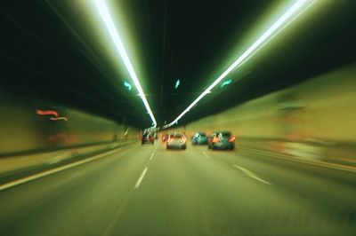 Blurred motion of people walking on road at night