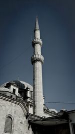 Low angle view of tower against blue sky