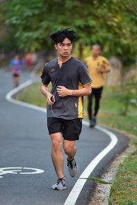 Full length of young man on road