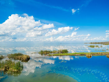 Scenic view of swimming pool by lake against sky