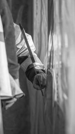 Cropped hands of man using tool on wood