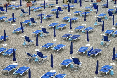 High angle view of empty chairs on beach