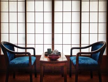 Empty chairs and table on floor at home