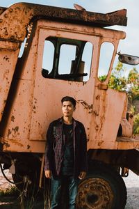 Portrait of man standing in abandoned building