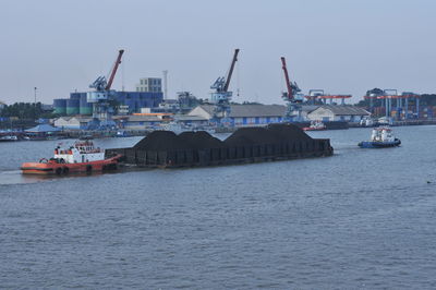 Sailboats in sea against sky